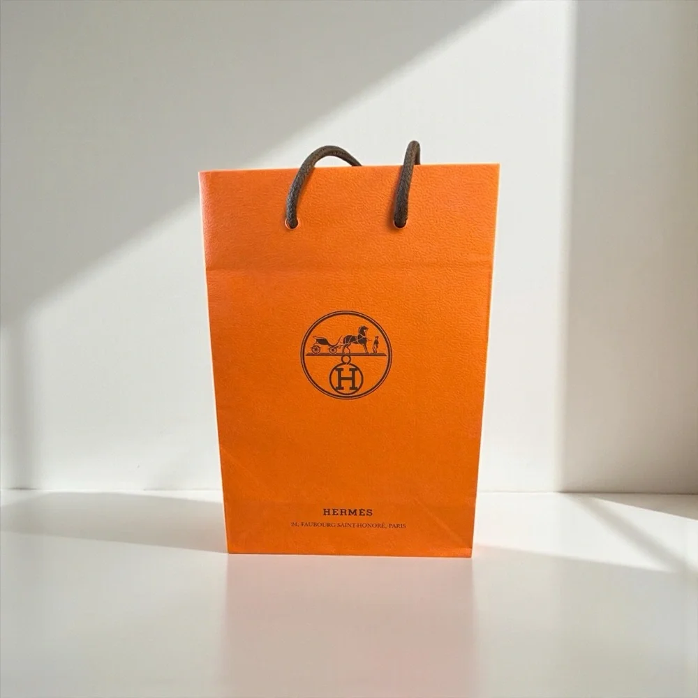 Hermès Vibrant Orange Bag with Elegant Cards
